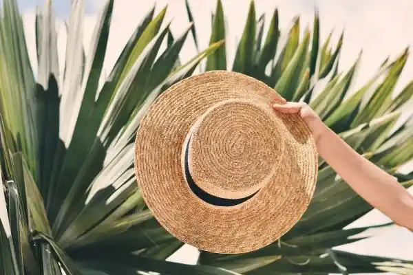 straw-hat-in-from-of-palm-tree