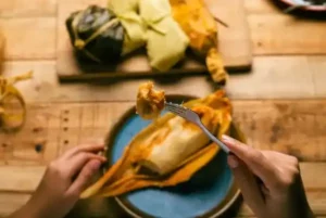 hands-of-a-person-cutting-a-tamale-Mexican Tamales recipe